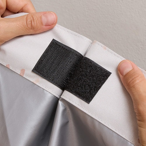 Parent using velcro on a portable blackout blind